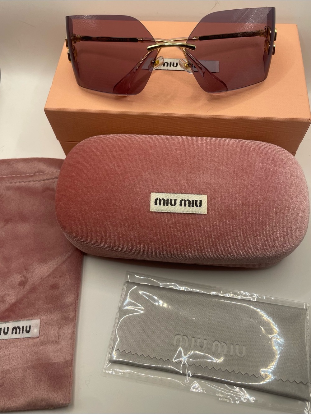 Miu Miu Rimless Sunglasses with Rose-Tinted Lenses and Gold Bridge